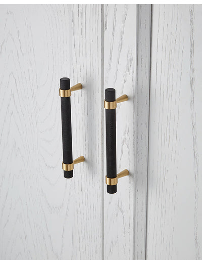 Black with brushed gold cabinet door handles and knobs