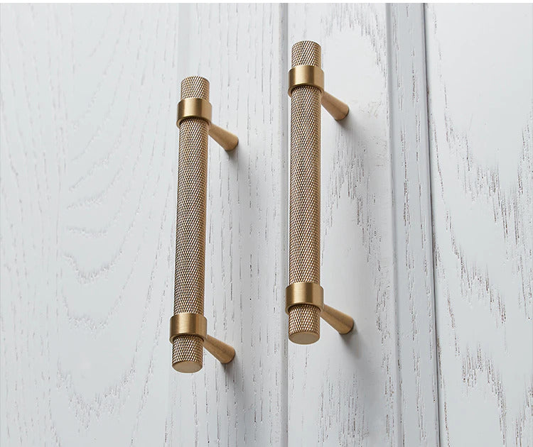 Black with brushed gold cabinet door handles and knobs